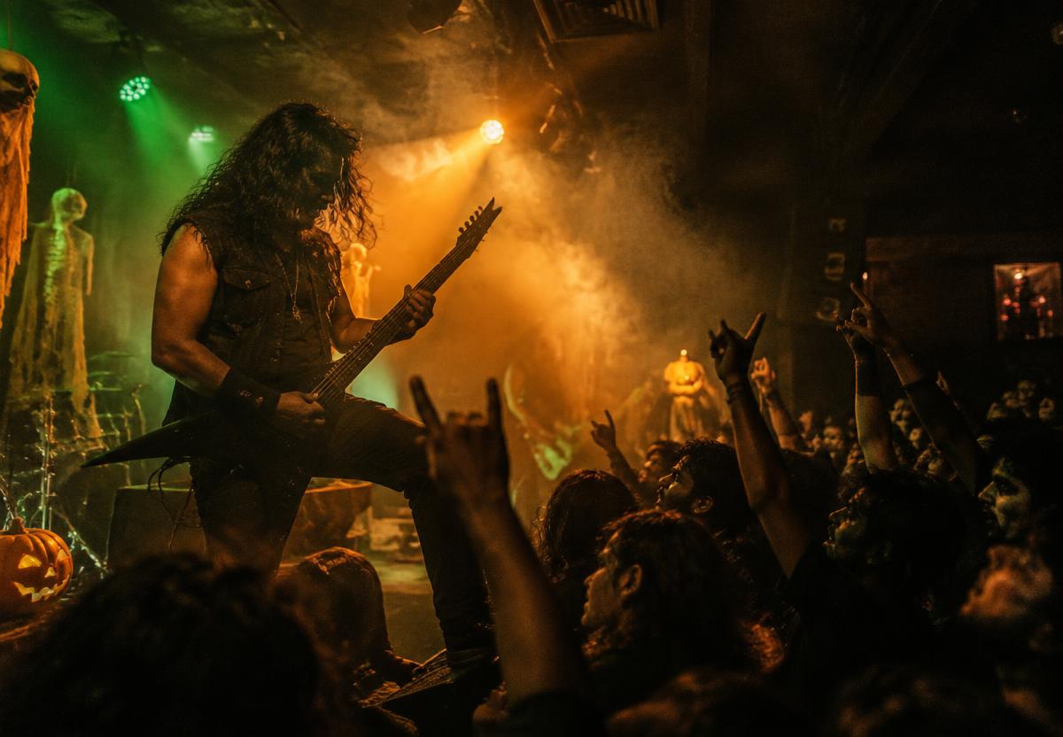 A guitarist performing heavy metal for an energetic crowd